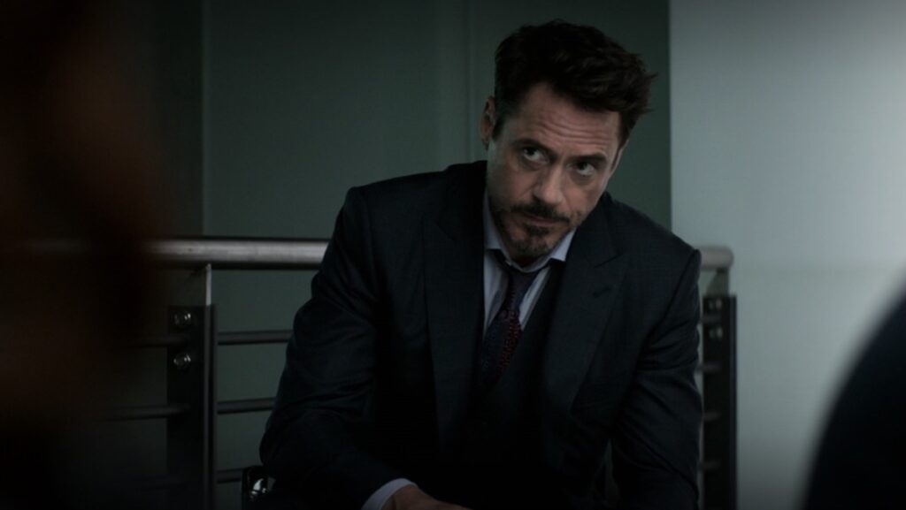 Tony Stark sitting down in a suit in Captain America: Civil War