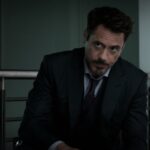 Tony Stark sitting down in a suit in Captain America: Civil War