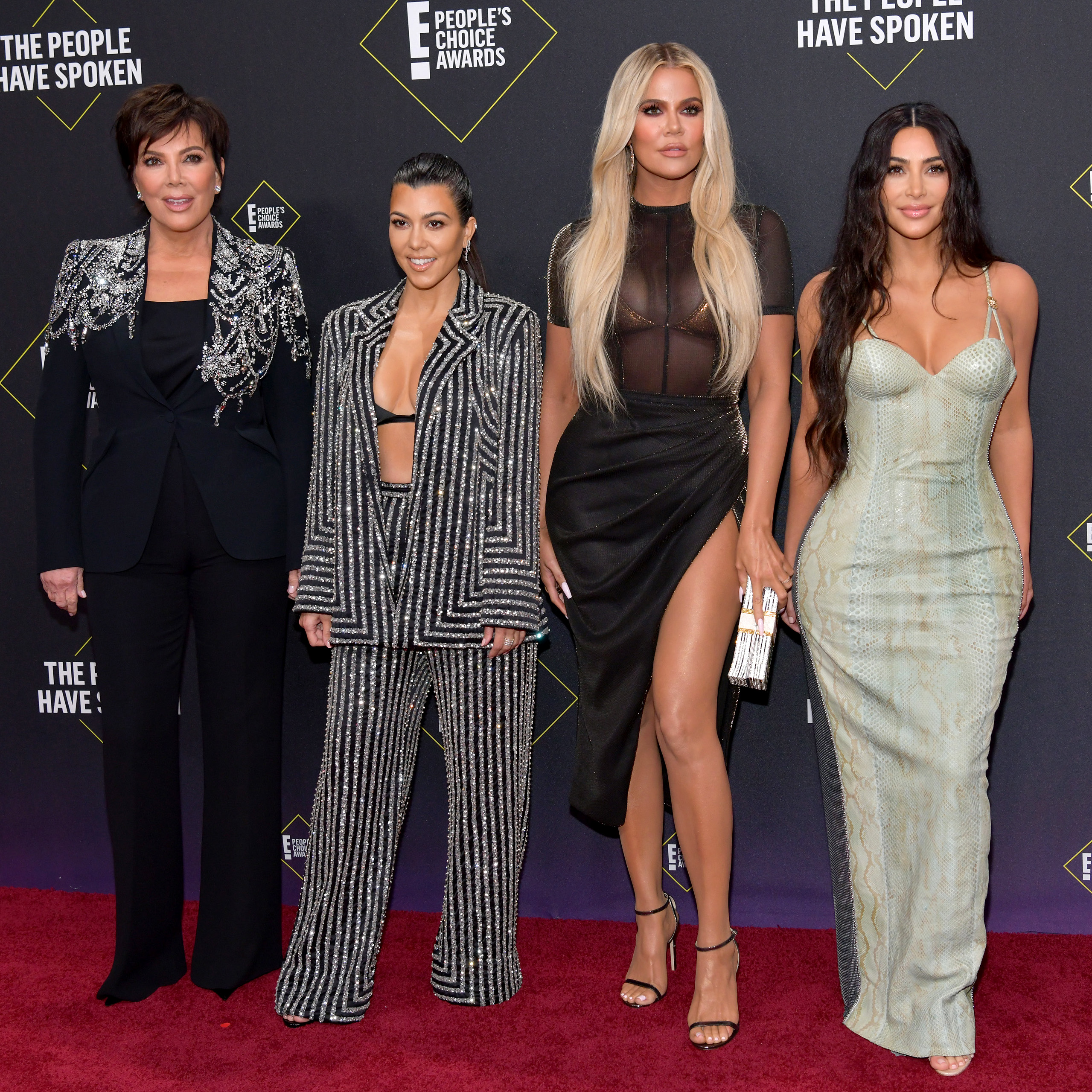 Kris Jenner posing with her daughters Kourtney, Khloé, and Kim at the 2019 E! People's Choice Awards