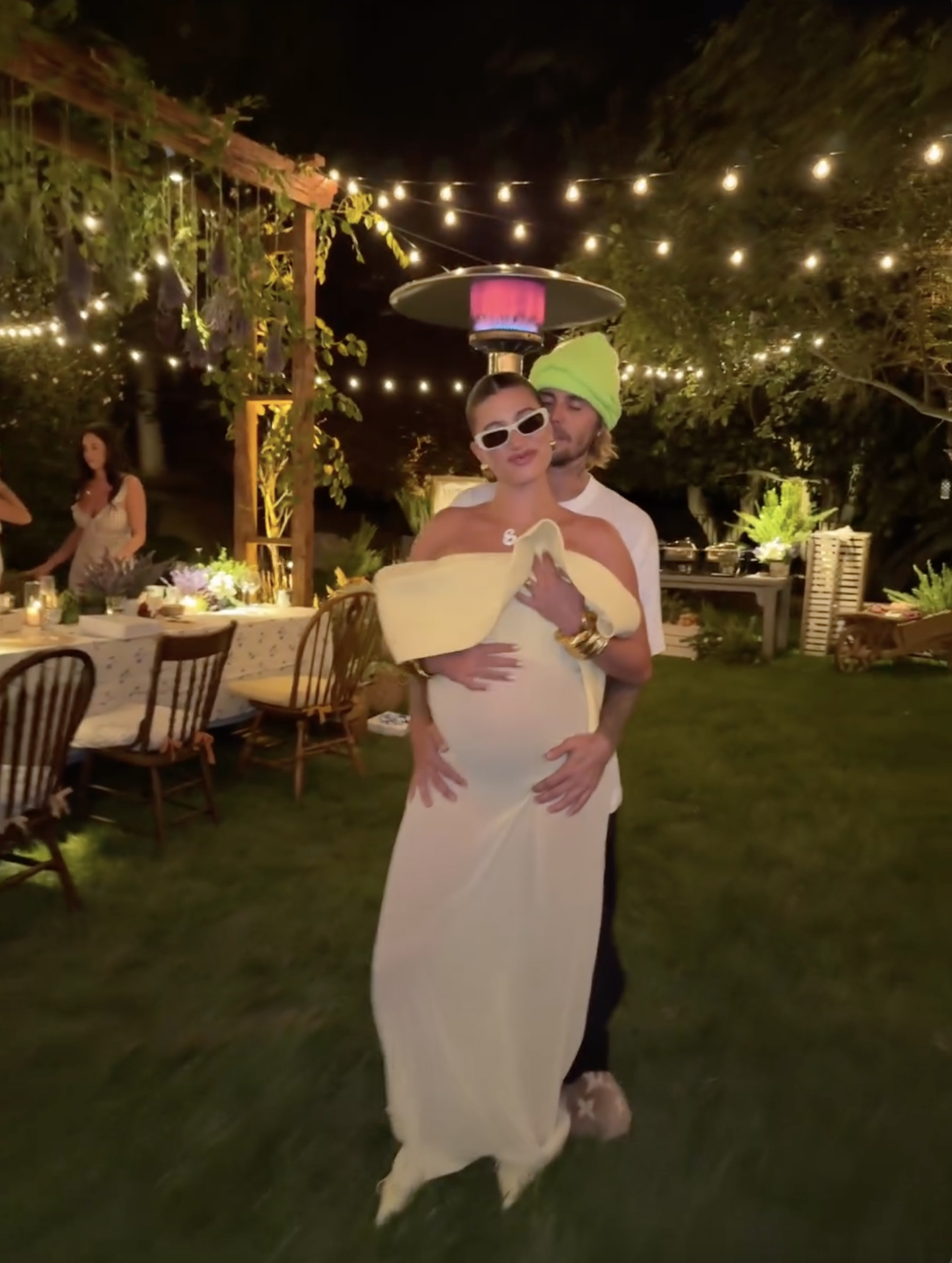 The couple were seen standing in the middle of a lavish dinner bash, as they await the birth of their first child together