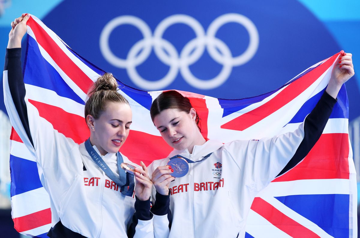 Bronze Medalists Andrea Spendolini-Sirieix and Lois Toulson of Team Great Britain pose with the national flag of Great Britain as they look at their medals following the medal ceremony after the Women's Synchronised 10m Platform Final on day five of the Olympic Games Paris 2024 at Aquatics Centre on July 31, 2024, in Paris, France. (Photo by Clive Rose/Getty Images)