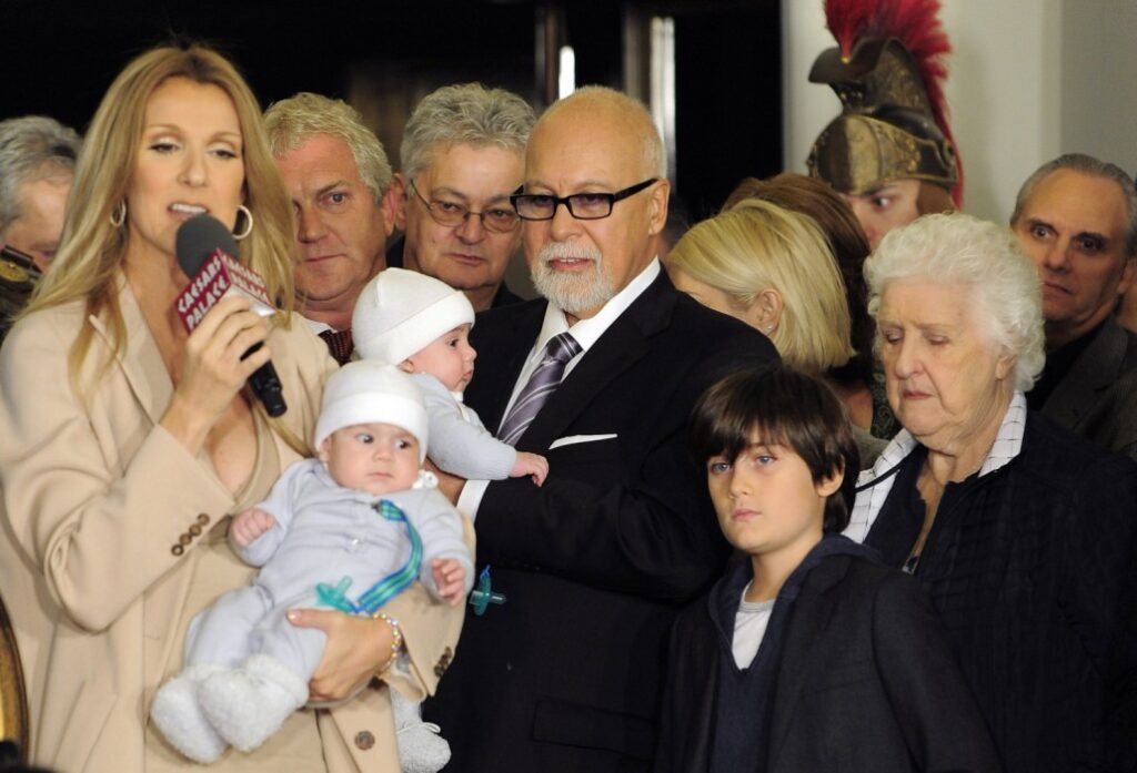 Celine Dion holds her son Nelson while husband and manager Rene Angelil holds their son Eddy, next to son Rene-Charles and Dion's mother Therese in 2011