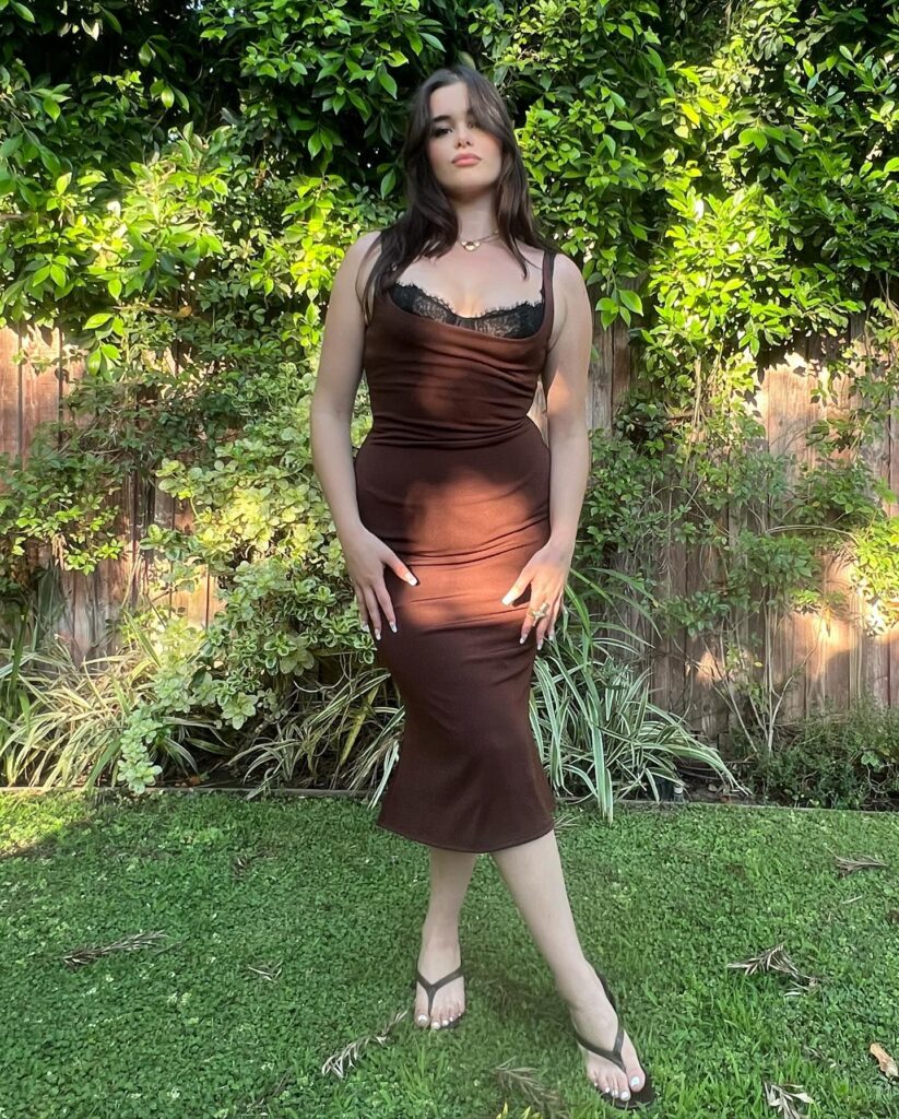 Barbie Ferreira showed off her new look in a tight brown midi-dress, posing for the camera in a grassy backyard