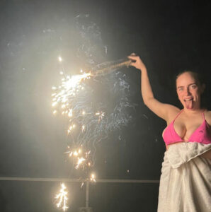 Billie Eilish shared a rare snap in a bikini top as she held a firework on July 4