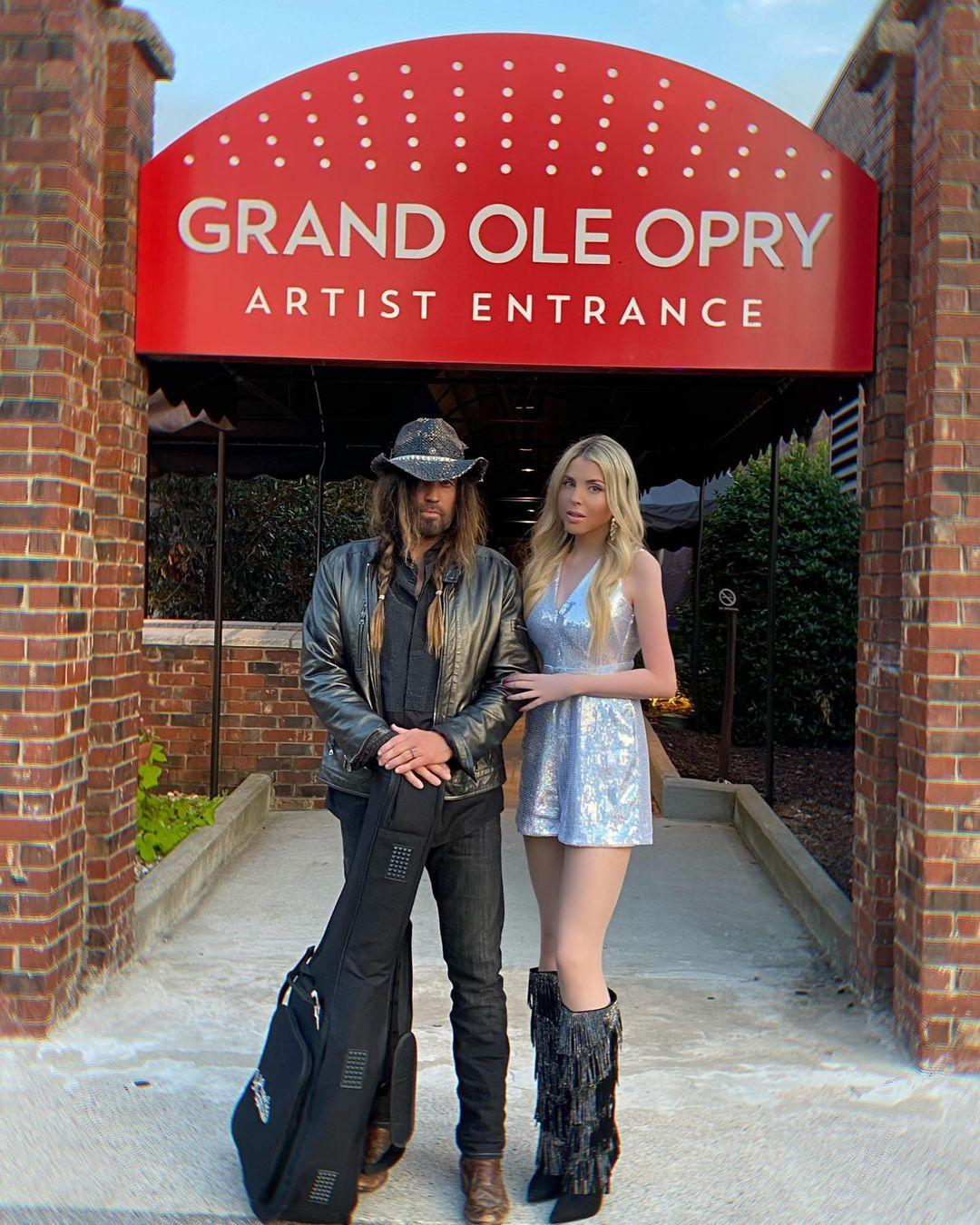 Firerose and Billy Ray Cyrus pose together outside the Grand Ole Opry