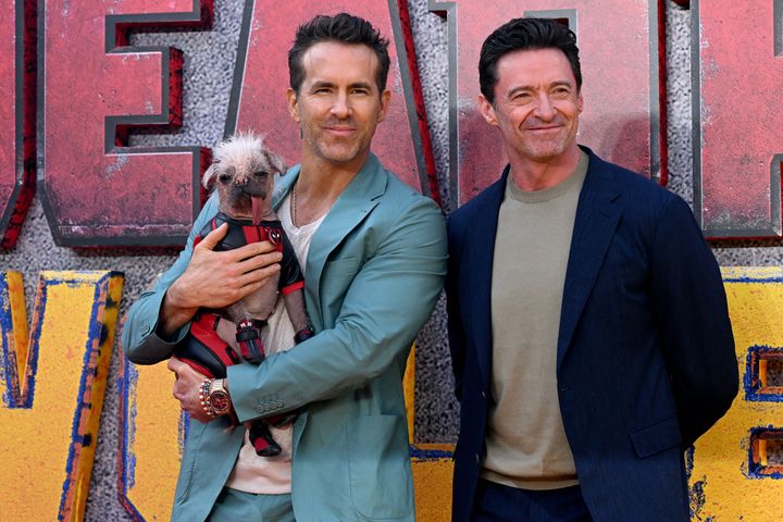 "Deadpool & Wolverine" actors Ryan Reynolds, left, and Hugh Jackman pose with Peggy, the United Kingdom's "ugliest dog."