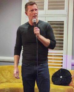 Comedian Tony Knight performing at a stand-up show