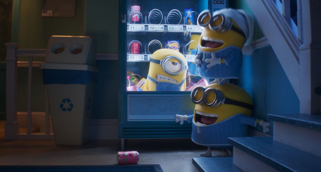 A Minion trapped in a vending machine, while two other Minions laugh and mock him