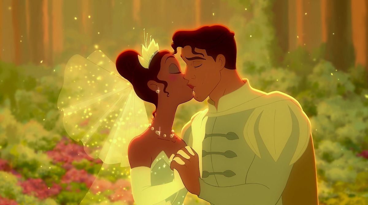 Tiana and Naveen share a kiss on their wedding day, decked out in green regalia 