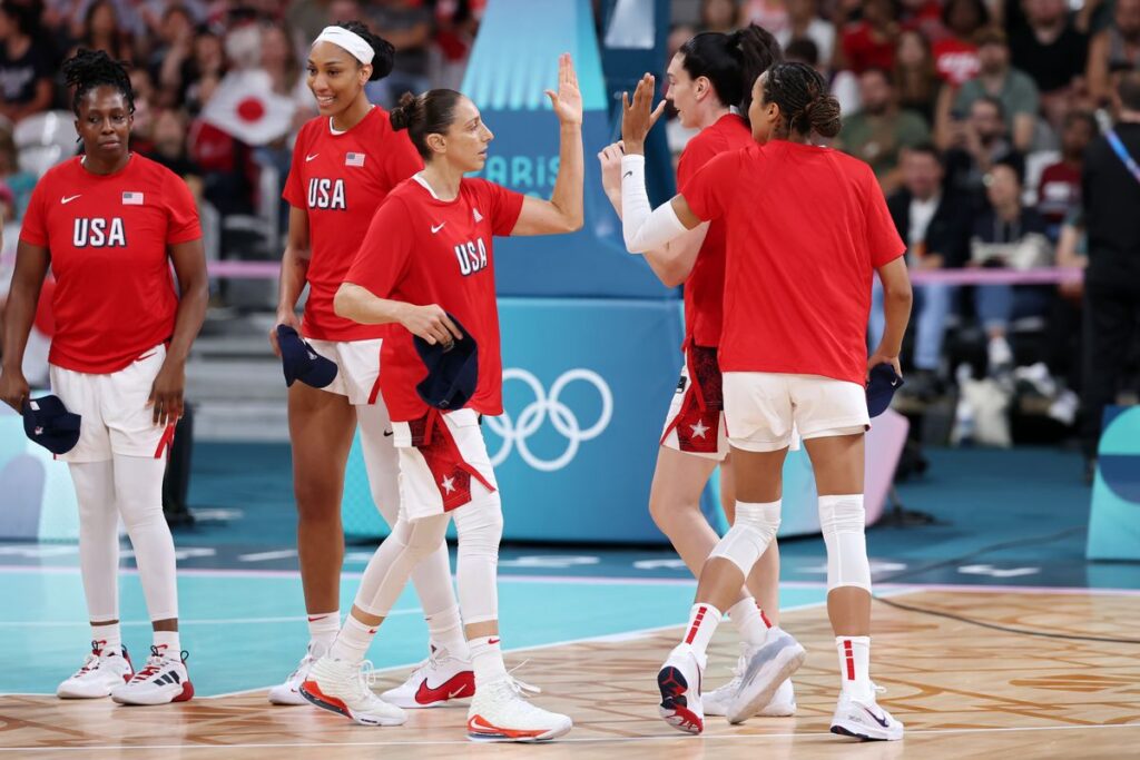 Diana Taurasi #12 of Team United States high fives teammates before the Women's Group Phase - Group B game between Japan and the United States on day three of the Olympic Games Paris 2024 at Stade Pierre Mauroy on July 29, 2024, in Lille, France. (Photo by Gregory Shamus/Getty Images)