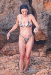 Singer Katy Perry shows off her physique on the beaches of Ibiza in a tiny bikini