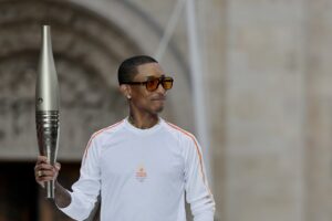 Pharrell Williams with the Olympic torch