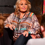 Roseanne Barr, seen at live podcast at Stand Up NY in 2018, has come to Ingrid Andress' defense