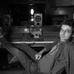 Steve Albini sitting in a studio with his feet propped up on the mixing board