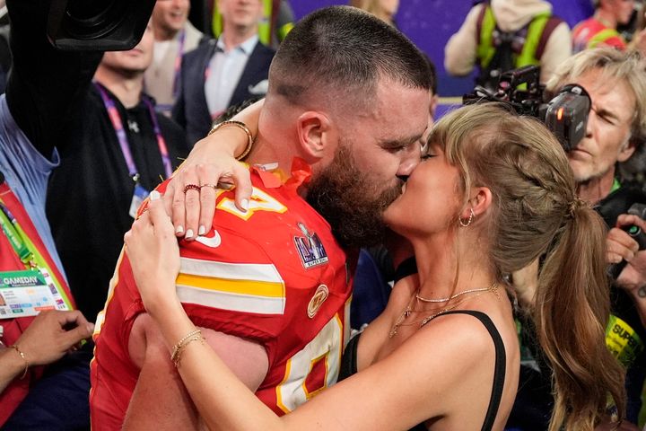 Kansas City Chiefs tight end Travis Kelce kisses his pop star girlfriend, Taylor Swift, after his team won the Super Bowl on Feb. 11 in Las Vegas.