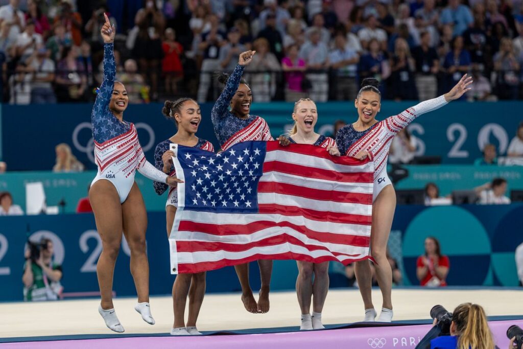 The United States team of Jordan Chiles, Hezly Rivera, Simone Biles, Jade Carey, and Sunisa Lee celebrate after the team's victory during the Artistic Gymnastics Team Final for Women at the Bercy Arena during the Paris 2024 Summer Olympic Games on July 30th, 2024 in Paris, France. (Photo by Tim Clayton/Corbis via Getty Images)