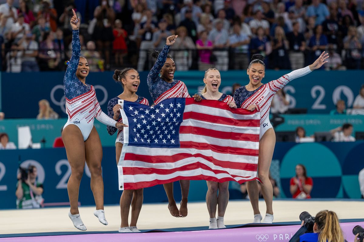 The United States team of Jordan Chiles, Hezly Rivera, Simone Biles, Jade Carey, and Sunisa Lee celebrate after the team's victory during the Artistic Gymnastics Team Final for Women at the Bercy Arena during the Paris 2024 Summer Olympic Games on July 30th, 2024 in Paris, France. (Photo by Tim Clayton/Corbis via Getty Images)