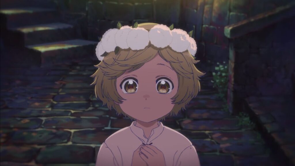 A young anime girl wearing a flower crown stares intensely with large gold-colored eyes and her hands clasped in Witch Hat Atelier.