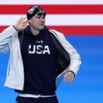 Nic Fink of Team United States gestures as he walks out ahead of the Men's 100m Breaststroke Final on day two of the Olympic Games Paris 2024 at Paris La Defense Arena on July 28, 2024 in Nanterre, France.