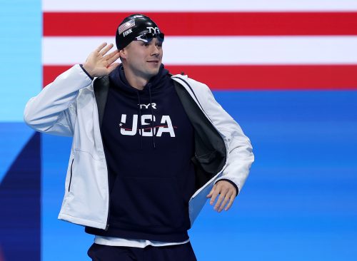 Nic Fink of Team United States gestures as he walks out ahead of the Men's 100m Breaststroke Final on day two of the Olympic Games Paris 2024 at Paris La Defense Arena on July 28, 2024 in Nanterre, France.