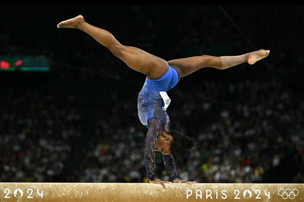 US' Simone Biles competes in the balance beam event of the artistic gymnastics women's all around final during the Paris 2024 Olympic Games at the Bercy Arena in Paris, on August 1, 2024. (Photo by Lionel BONAVENTURE / AFP) (Photo by LIONEL BONAVENTURE/AFP via Getty Images)