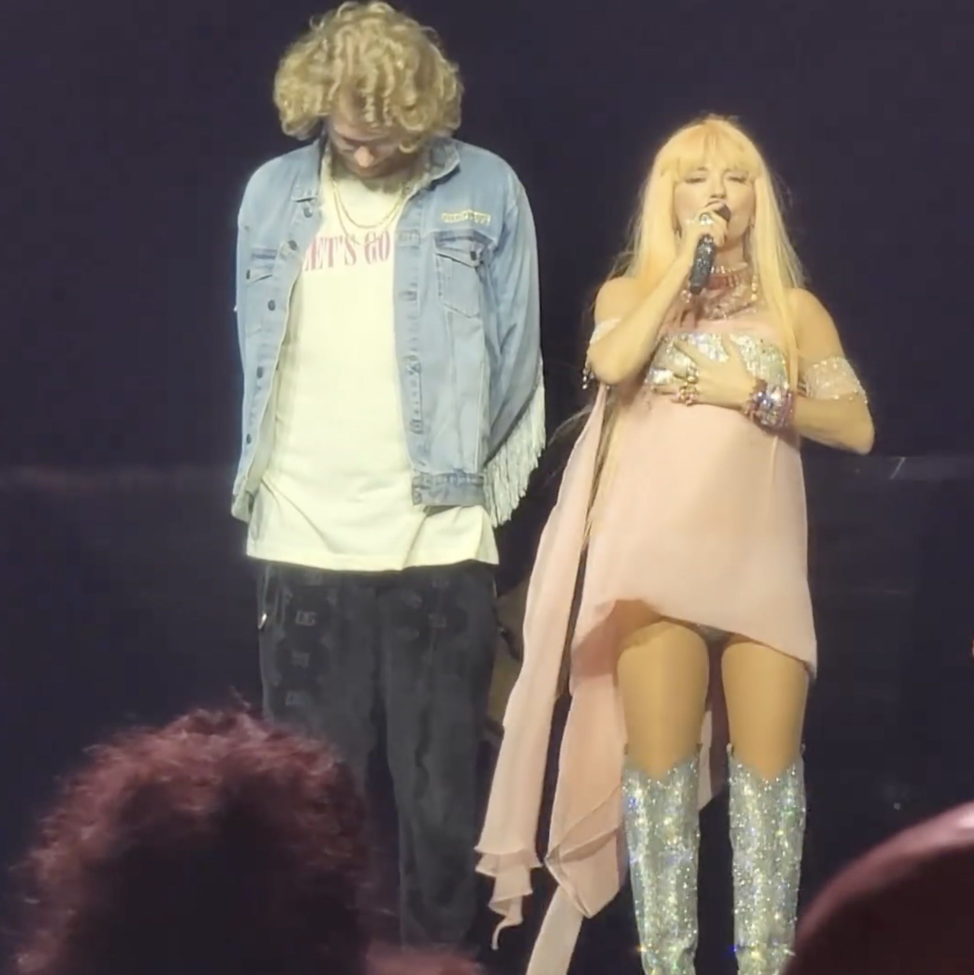 The country singer wore a small pink dress with sparkly cowboy boots while on stage with Yung Gravy this week