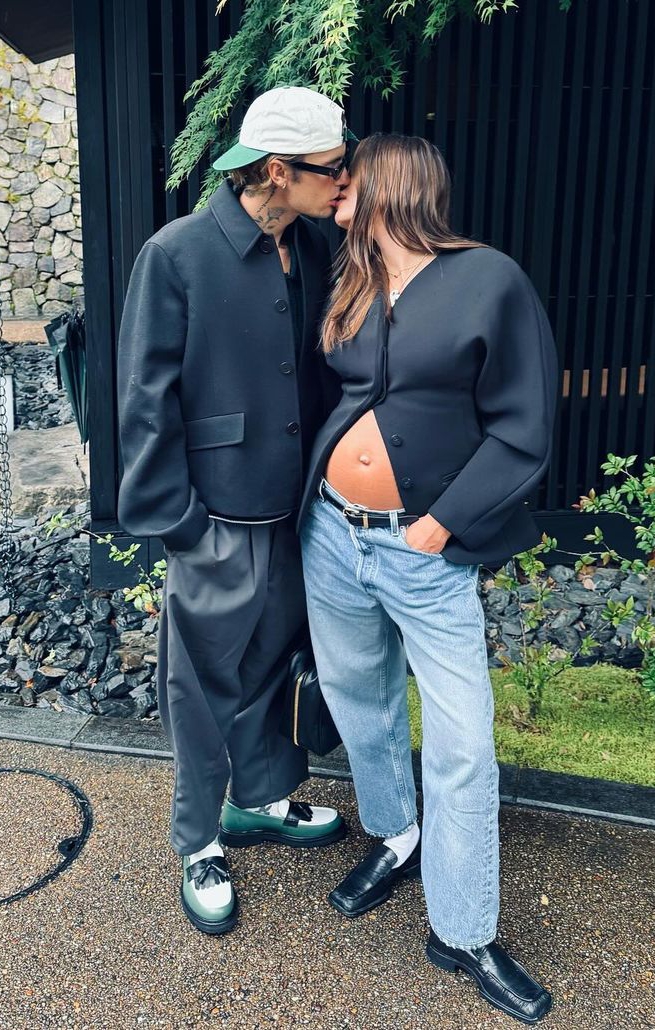 Hailey Bieber shows off baby bump and fashion sense as she kisses her husband, Justin Bieber