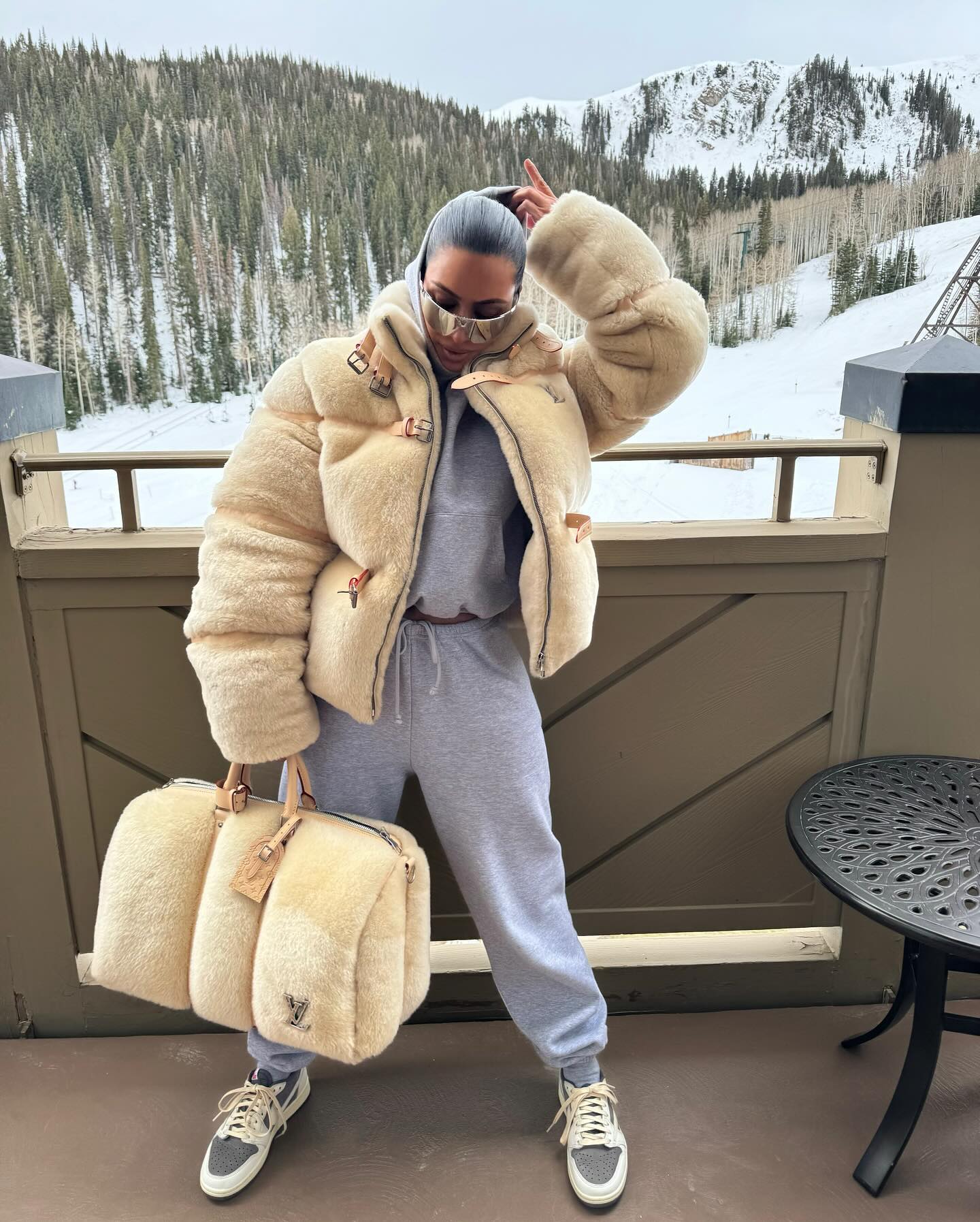 Kim Kardashian flaunts her wealth with a fur coat and Louis Vuitton bag on a snow vacation