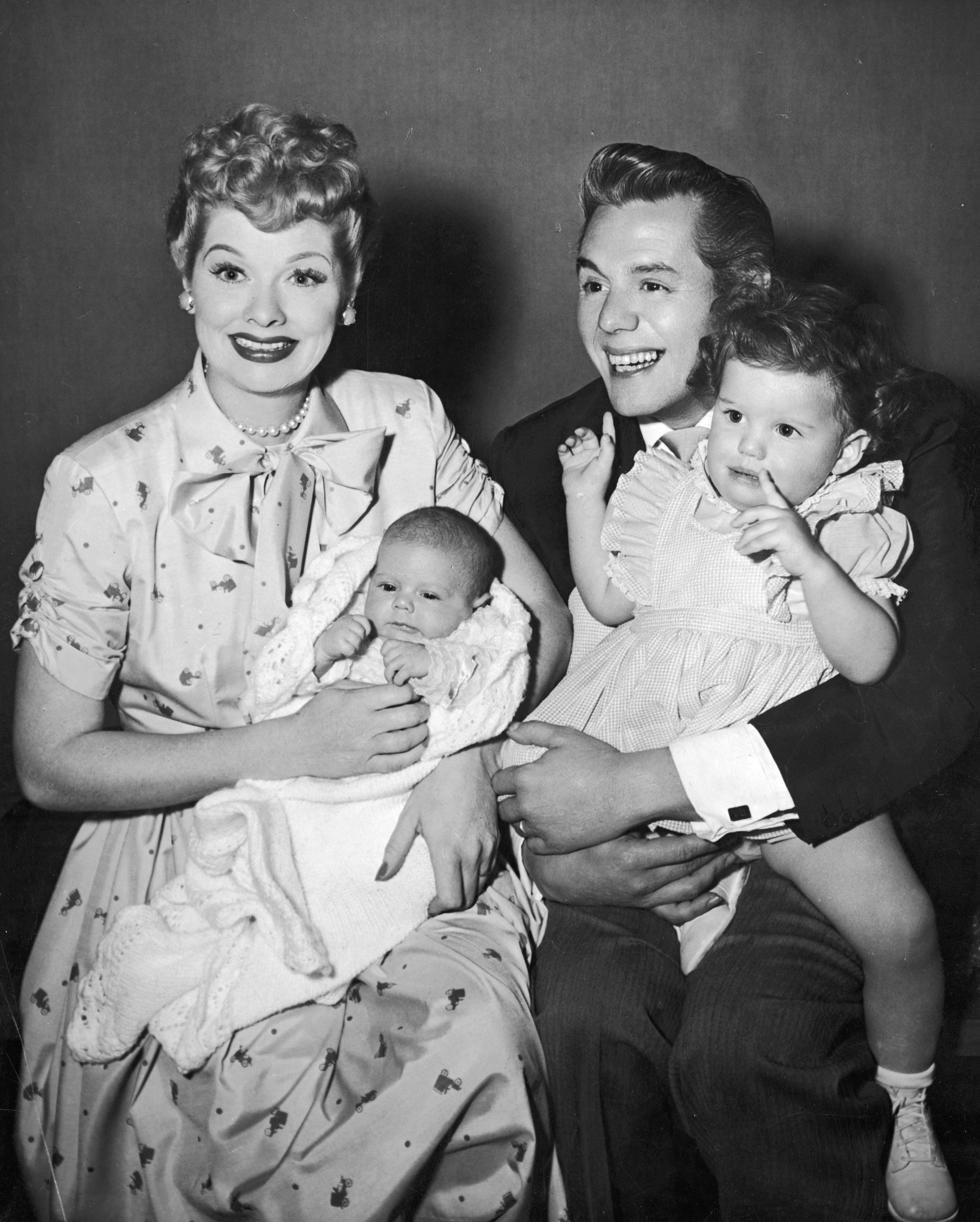 1953: American actors and comedian Lucille Ball  and her husband, Cuban-born actor and bandleader Desi Arnaz with their two children, Desi Jr (left) and Lucie