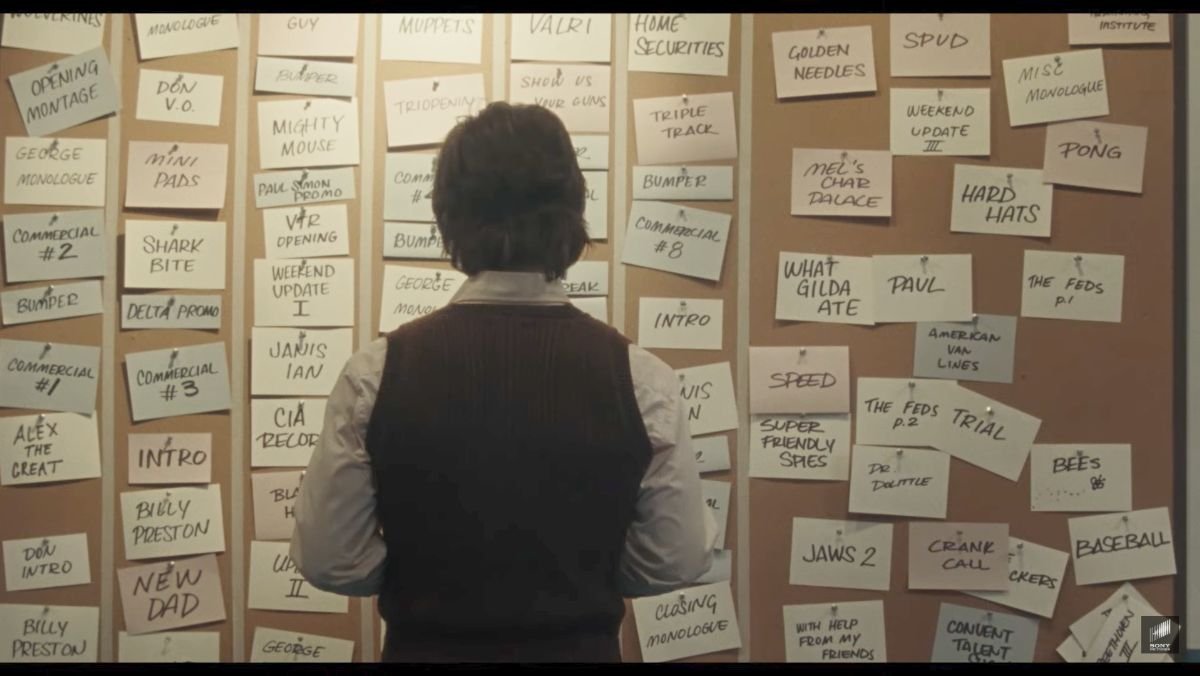 Saturday Night Live movie trailer shows man standing in front of a wall with sticky notes