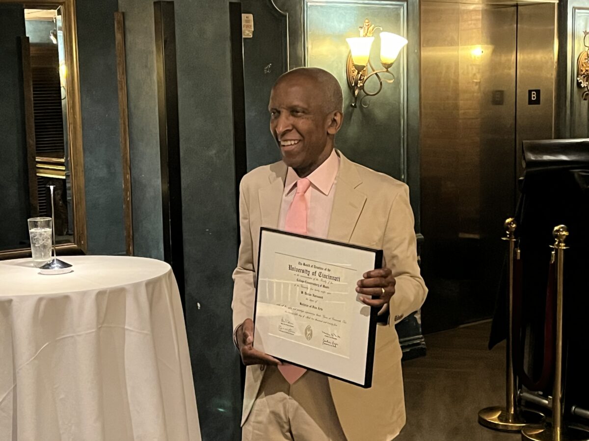 Dorian Harewood posing with his BFA degree from CCM