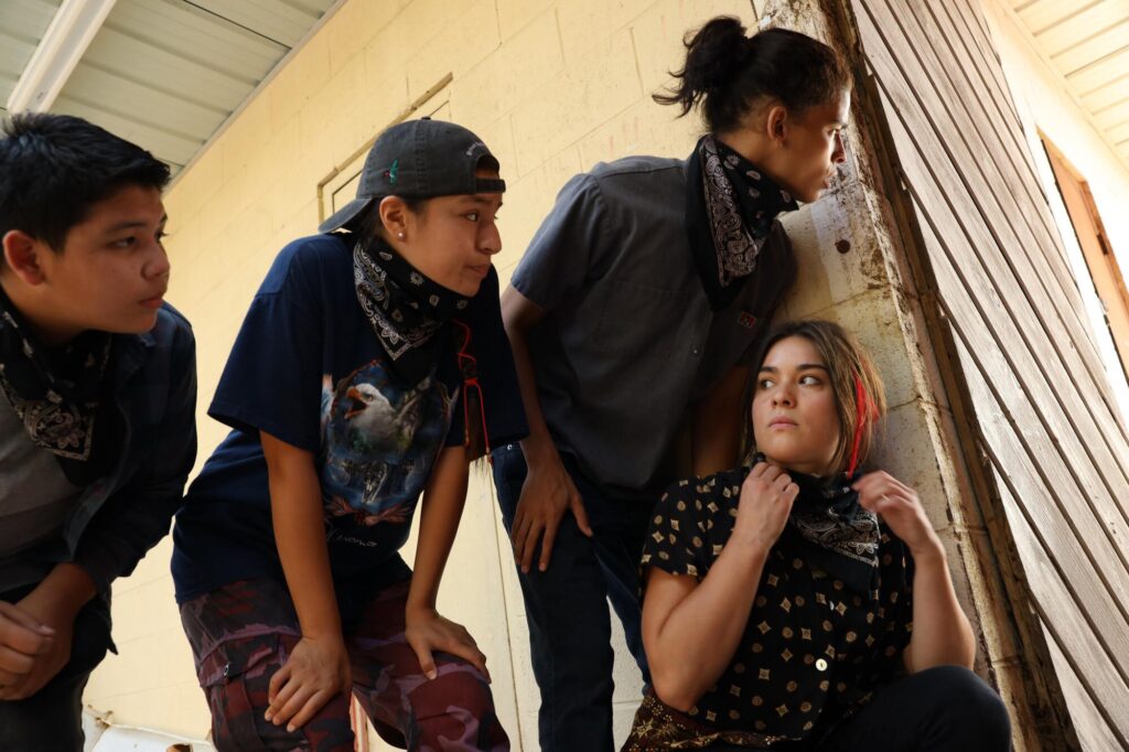 Four teens peek around a wall in "Reservation Dogs."