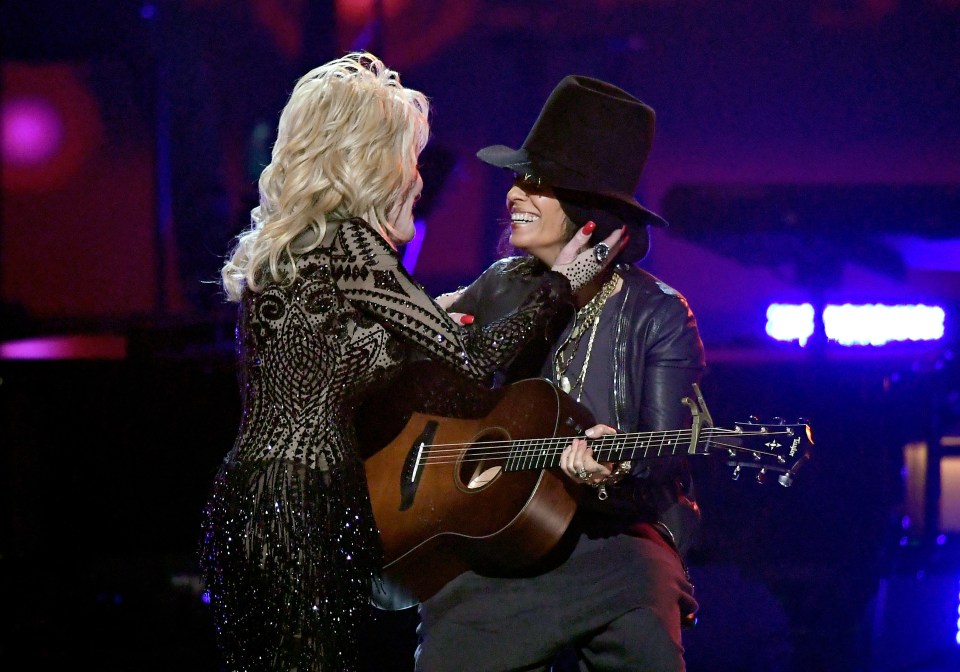 Dolly Parton (L) and Linda Perry perform onstage during MusiCares Person of the Year honoring Dolly Parton at Los Angeles Convention Center on February 8, 2019