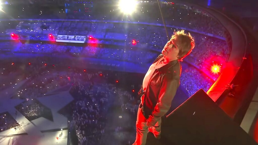 Tom Cruise standing on top of the Stade de Paris during the 2024 Summer Olympics closing ceremony