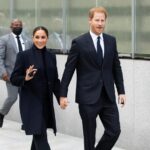 Prince Harry and Meghan Markle walking and smiling