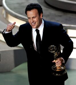 Mitch Hurwitz holds an Emmys statue as he delivers an acceptance speech on stage.