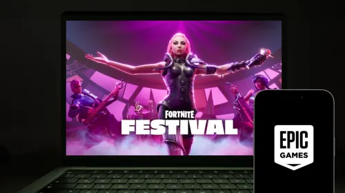 Istanbul, Turkey - February 22, 2024: Epic Games logo on a smartphone screen with Lady Gaga Fortnite Festival on a computer at the background