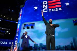 Rapper Common (R) and musician Jonathan McReynolds perform during the second day of the Democratic National Convention at the United Center on August 20, 2024 in Chicago, Illinois.