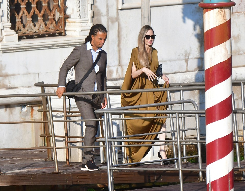 Akala and Angelina Jolie in a deep conversation while exiting a Venice hotel