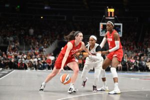 Caitlin Clark #22 of the Indiana Fever handles the ball as Jordin Canada #3 of the Atlanta Dream plays defense on Aug 26