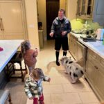 Arnold Schwarzenegger is seen feeding a pig in the middle of his kitchen surrounded by his daughter, Katherine, and Chris Pratt's two daughers