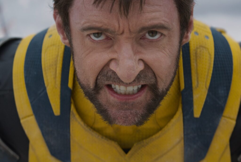 Hugh Jackman as Wolverine snarls into the camera in closeup in Deadpool & Wolverine