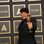 Troy Kotsur holding his Academy Award, which he won for his performance in 'CODA'