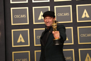 Troy Kotsur holding his Academy Award, which he won for his performance in 'CODA'