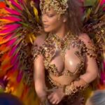 Rihanna was spotted at Carnival Festival in Barbados wearing a revealing outfit and appeared to cover her stomach amid pregnancy rumors