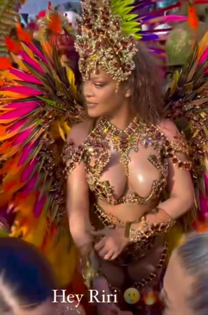 Rihanna was spotted at Carnival Festival in Barbados wearing a revealing outfit and appeared to cover her stomach amid pregnancy rumors