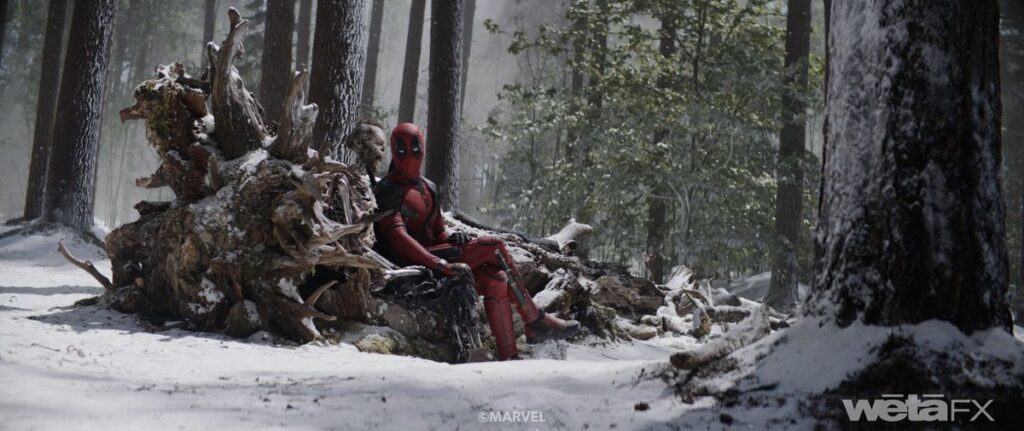 Deadpool (Ryan Reynolds) sits on a fallen tree in a snowy forest next to the rotted corpse of Wolverine (Hugh Jackman) in Deadpool & Wolverine