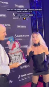 Shania Twain is seen taking a bite out of her 59th birthday cake on the carpet of the Bakkt Theater in Las Vegas