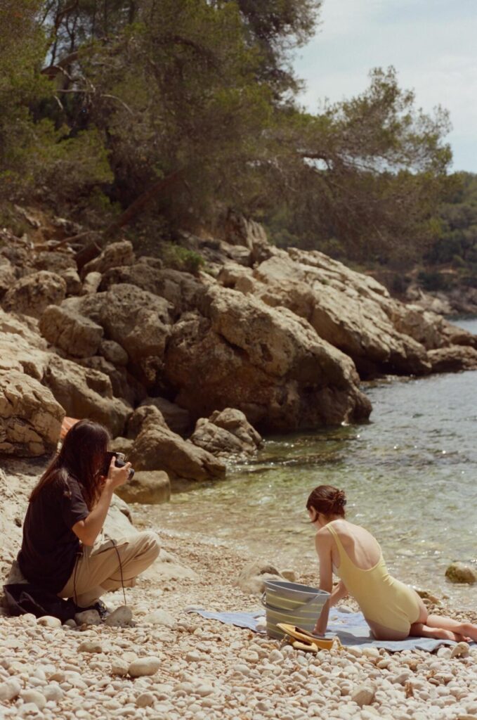 Director Durga Chew-Bose, left, photographs actor Lily McInerny on the set of "Bonjour Tristesse."