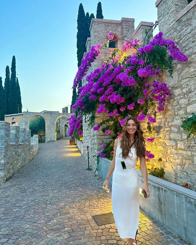 Model Hana Mayeda sporting an all-white dress while vacationing in Italy during the summer of 2023